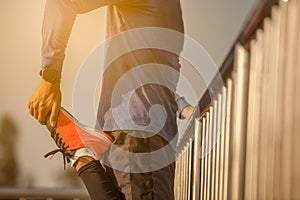 Runer stretching at sunset