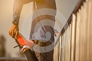 Runer stretching at sunset