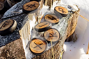 Runes carved from wood on the snow - Elder Futhark