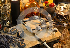 Runes, magic wand and pentagram on witch table