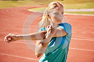 Runner, arms and woman stretching in stadium for race, marathon or competition training for health. Sports, fitness and
