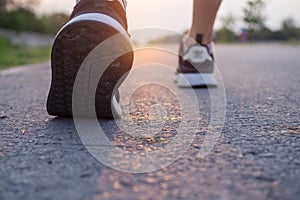 Runner athlete feet running on road. woman fitness silhouette sunrise jog workout wellness concept