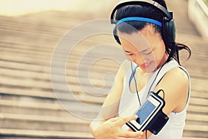 Runner athlete listening to music in headphones fr