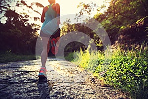 Runner athlete running on forest trail