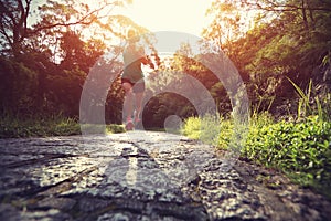 Runner athlete running on forest trail