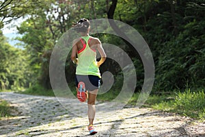 Runner athlete running on forest trail