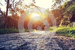 Runner athlete running on forest trail