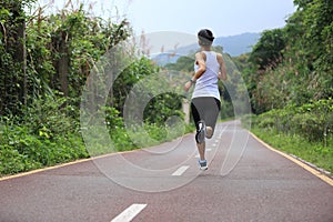 Runner athlete running on forest trail