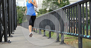 Runner athlete running on iron bridge