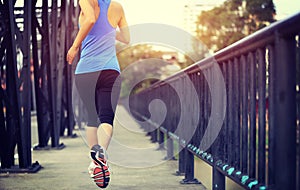 Runner athlete running on iron bridge photo