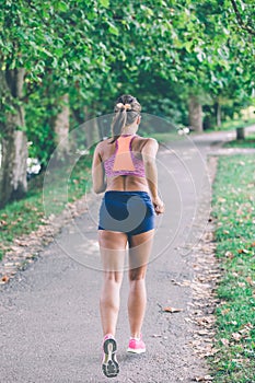 Runner athlete running at park. woman fitness jogging workout wellness concept.