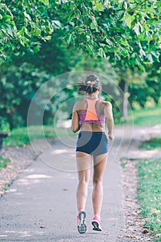 Runner athlete running at park. woman fitness jogging workout wellness concept.