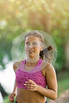 Runner athlete running at park. woman fitness jogging workout wellness concept.