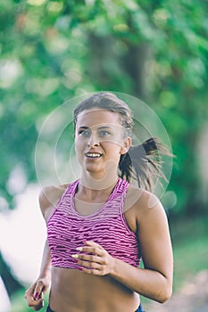 Runner athlete running at park. woman fitness jogging workout wellness concept.