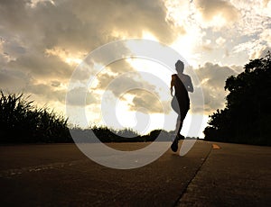 Runner athlete running at seaside road