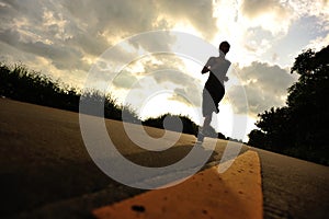 Runner athlete running at seaside road