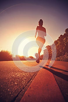 Runner athlete running at seaside road