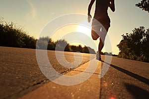 Runner athlete running at seaside road