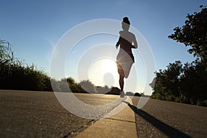 Runner athlete running at seaside road