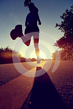 Runner athlete running at seaside road