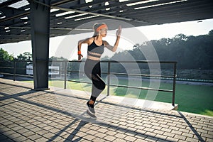 Runner athlete running on stairs. woman fitness jogging workout wellness concept.