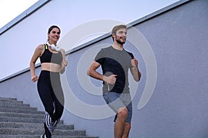 Runner athletes running on stairs. Couple fitness is jogging oudoors