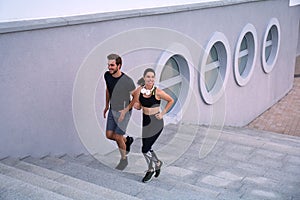 Runner athletes running on stairs. Couple fitness is jogging oudoors