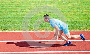 Runner captured in motion just after start of race. Boost speed concept. Man athlete runner push off starting position