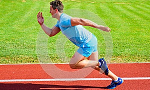 Runner captured in motion just after start of race. Runner sprint race at stadium. Boost speed concept. Man athlete