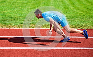 Runner captured in motion just after start of race. Runner sprint race at stadium. How to start running. Boost speed