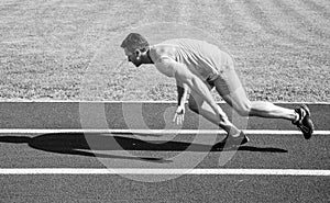 Runner captured in motion just after start of race. Runner sprint race at stadium. How to start running. Boost speed