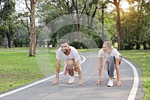 A runner caucasian couple is at starter for jogging in the park during summer season with smile healthy or sport concept