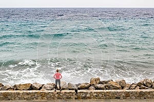 Runner on city street looking at inspiring sea view