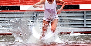 Runner competing in steeplechase lands in the water