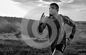 Runner concept. Athletic man running trail on sunset wearing in the sportswear. Fitness and sport motivation. Athlete