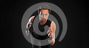 Runner concept. Sprinter run. Strong athletic man running on black background wearing in the sportswear. Fitness and