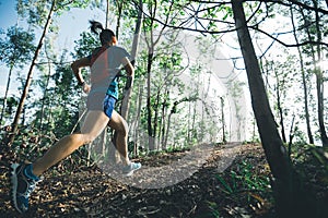 Runner cross country trail running in forest