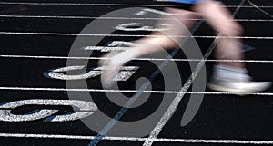 Runner Crossing the Finish Line of a Race on a Track Blurred