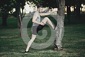 Runner doing stretching exercise before jogging