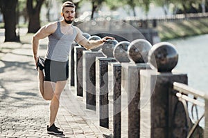 Runner doing stretching exercise before workout