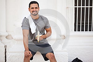 Runner eating a banana to recover photo