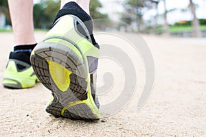 Runner feet on a path in a park