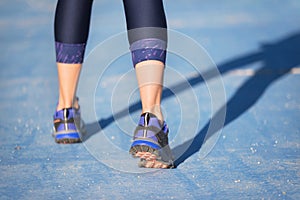 Runner feet running closeup on shoe. woman fitness jog workout welness concept.