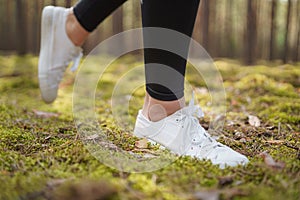 Runner feet running on road closeup on shoe.