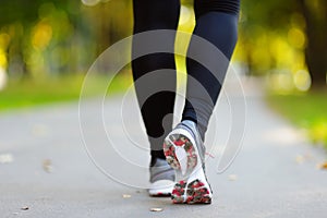 Runner feet running on road closeup on shoe