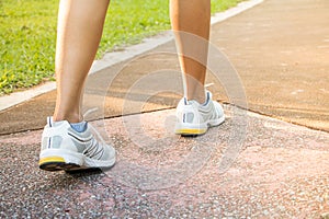 Runner feet running on road closeup on shoe.