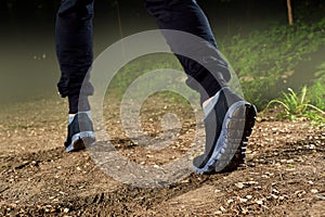 Runner feet running on road closeup on shoe. Workout welness con