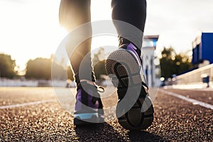 Runner feet running on road on shoe