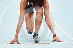 Runner, fitness and woman athlete at start on track, outdoor and exercise for sports competition. Race, kneel position