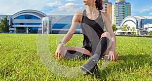 Runner girl resting on the football field. Sports concept